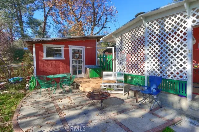 a view of backyard with a table and chairs