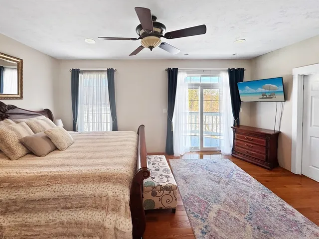 a bedroom with a large bed and a window