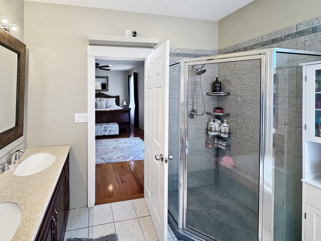 8 Dulcies Point Road Kingston, NH 03848 - Photo 17 of 27 a bathroom with a granite countertop sink a mirror and shower