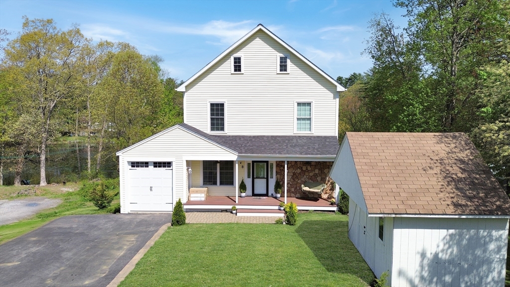 8 Dulcies Point Road Kingston, NH 03848 - Photo 2 of 27 a front view of a house with a yard porch and outdoor seating