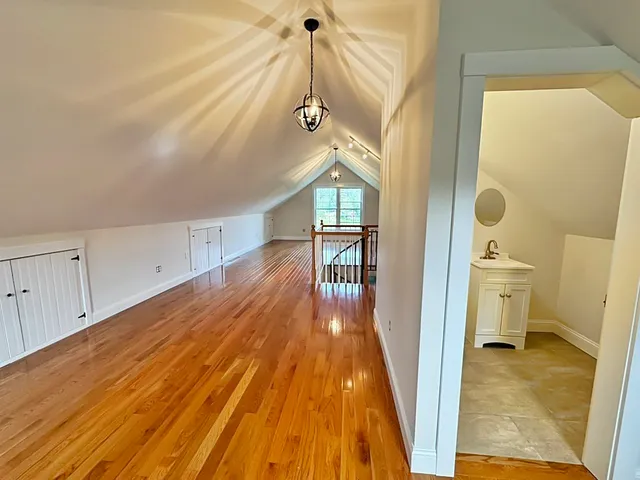 a view of a hallway view with wooden floor and staircase