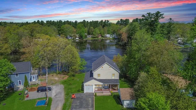 an aerial view of a house with garden space and street view