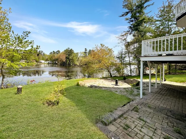 a view of yard with swimming pool and green space