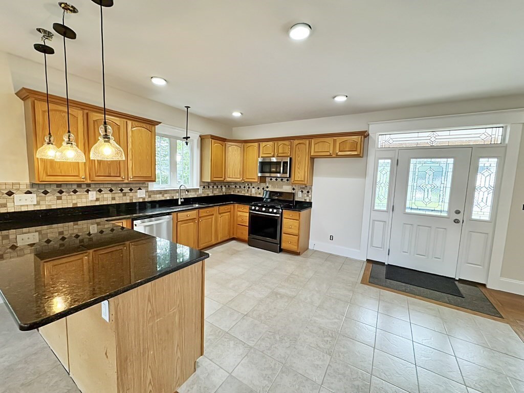 8 Dulcies Point Road Kingston, NH 03848 - Photo 7 of 27 a kitchen with stainless steel appliances granite countertop a sink counter space cabinets and a large window