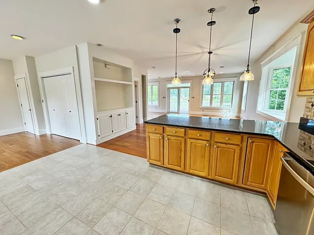 a bathroom with a granite countertop sink and a large window