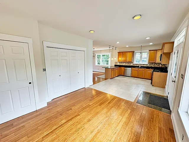 a large kitchen with kitchen island a large counter space a sink appliances and cabinets