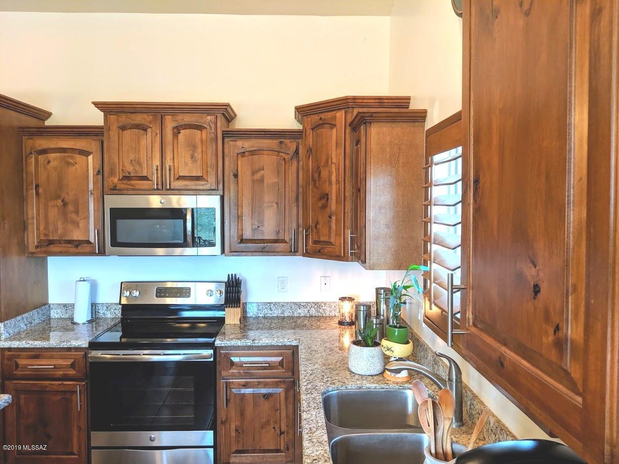 364 Annette Court Rio Rico, AZ 85648 - Photo 7 of 23 a kitchen with stainless steel appliances a stove and a microwave