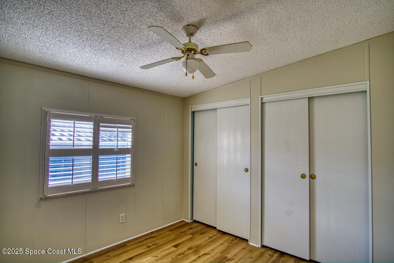2390 Coconut Palm Drive Palm Bay, FL 32905 - Photo 11 of 27 a view of a livingroom with a ceiling fan and a window