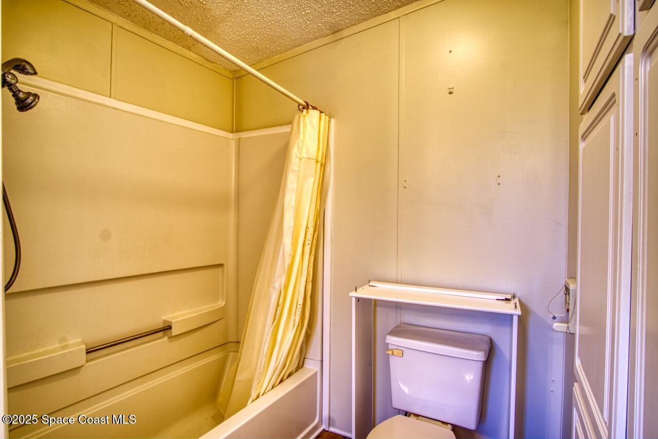 2390 Coconut Palm Drive Palm Bay, FL 32905 - Photo 14 of 27 a bathroom with a sink and a mirror