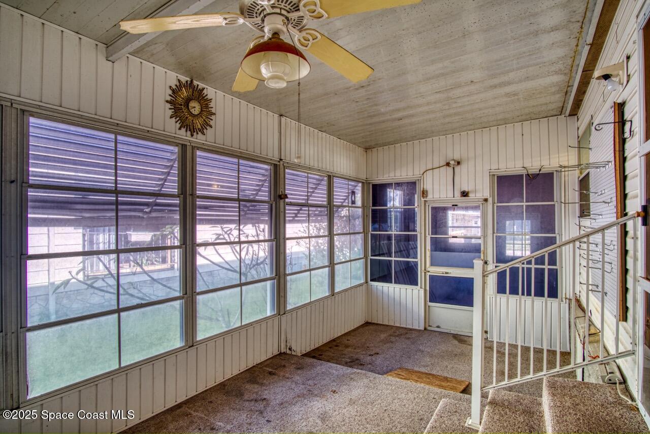2390 Coconut Palm Drive Palm Bay, FL 32905 - Photo 18 of 27 a view of a livingroom with a staircase