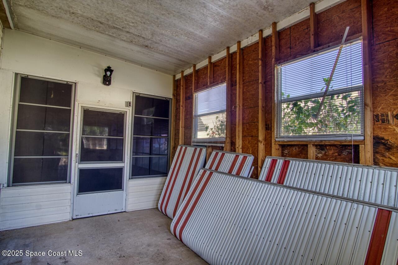 2390 Coconut Palm Drive Palm Bay, FL 32905 - Photo 19 of 27 a view of a balcony with furniture and floor to ceiling window