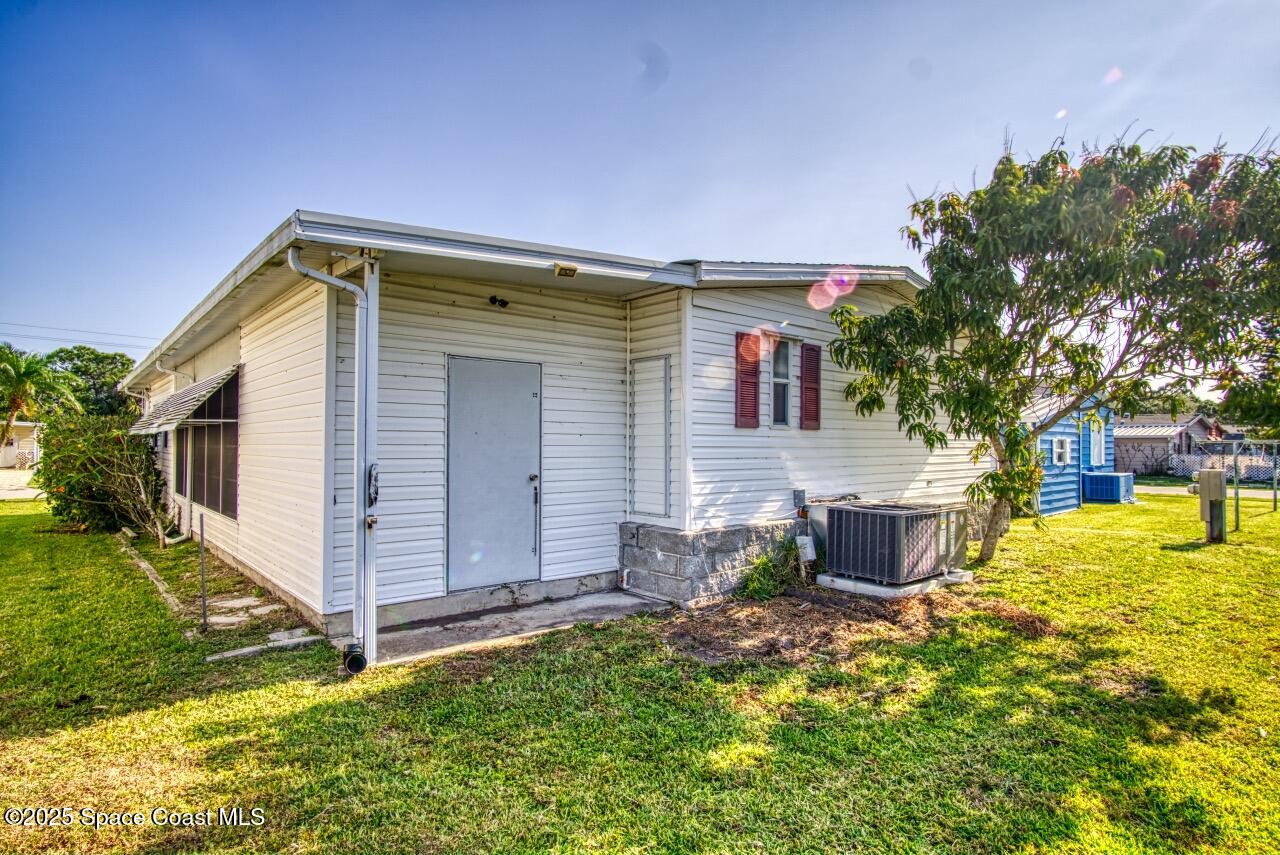 2390 Coconut Palm Drive Palm Bay, FL 32905 - Photo 21 of 27 a view of a house with a yard