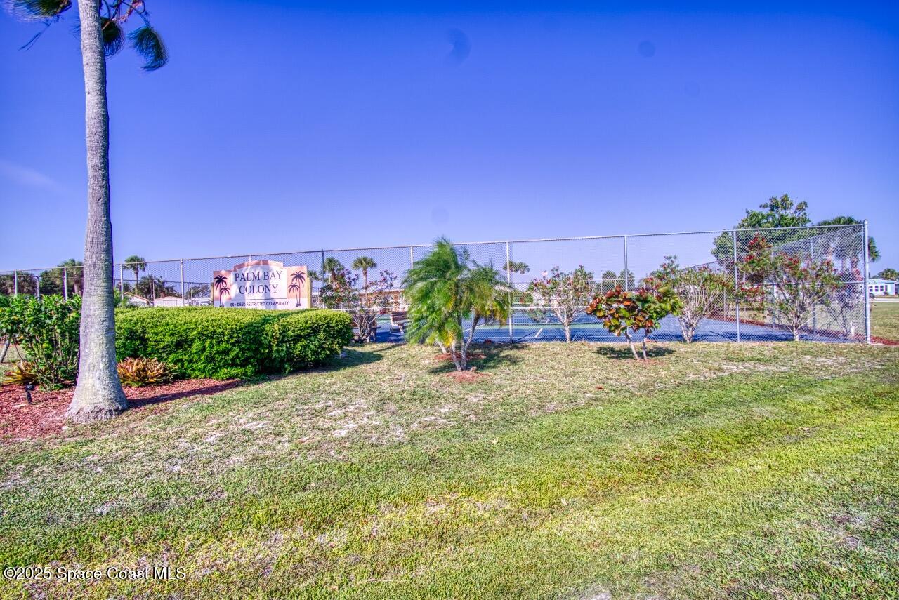 2390 Coconut Palm Drive Palm Bay, FL 32905 - Photo 22 of 27 a view of a garden with a building in the background