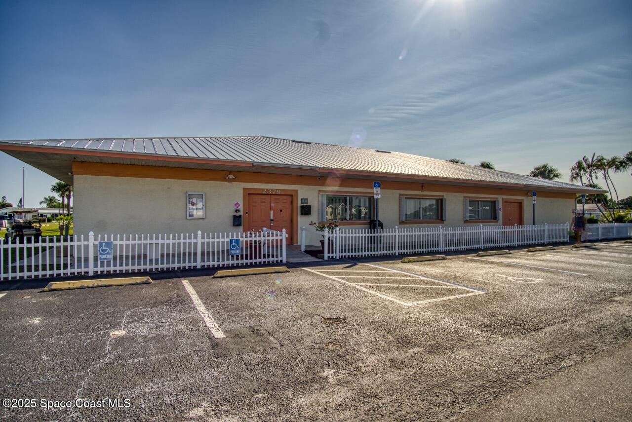 2390 Coconut Palm Drive Palm Bay, FL 32905 - Photo 24 of 27 a front view of a house with a garage