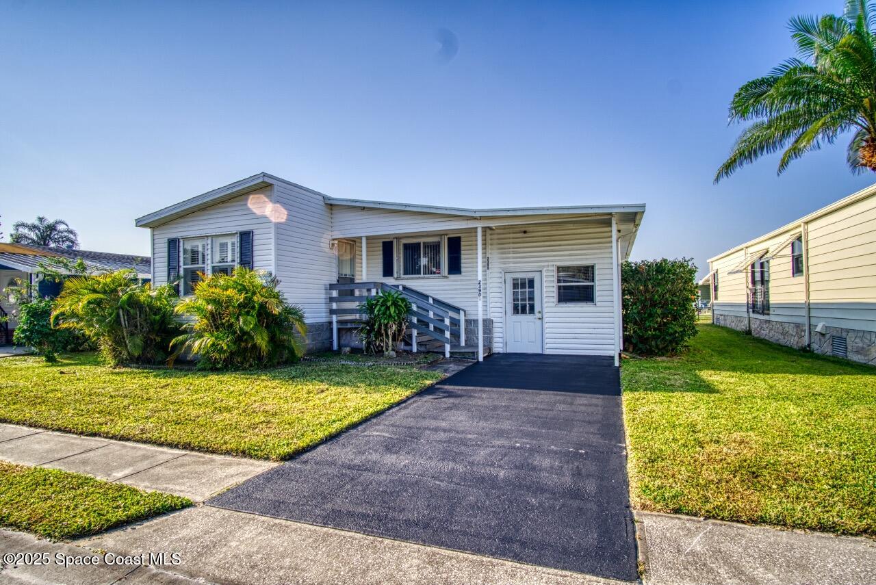 2390 Coconut Palm Drive Palm Bay, FL 32905 - Photo 3 of 27 a front view of house with yard and green space