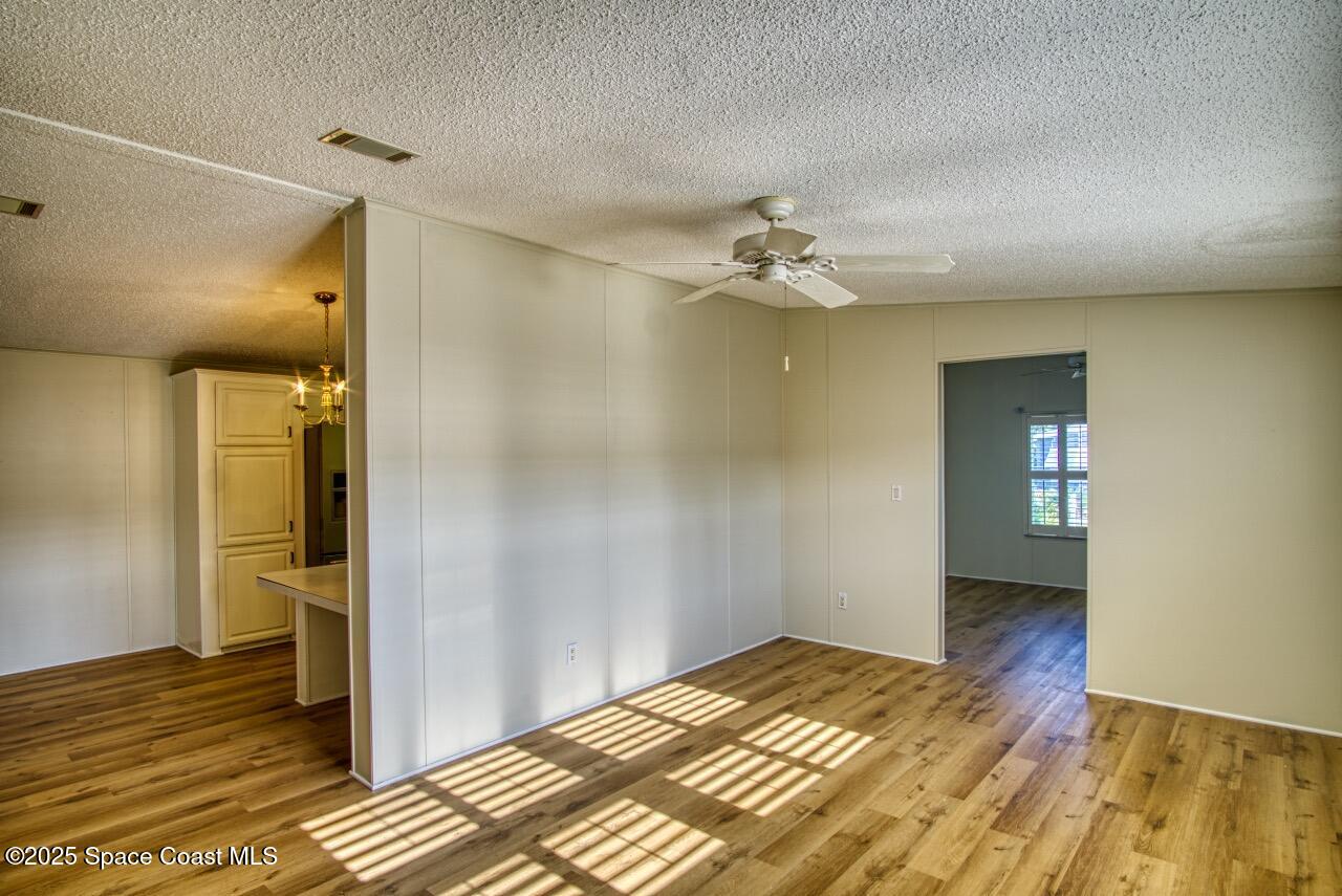 2390 Coconut Palm Drive Palm Bay, FL 32905 - Photo 6 of 27 a bedroom with a bed and a chandelier