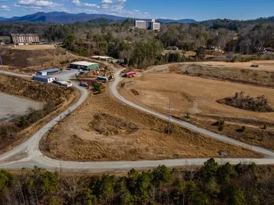 a view of mountain with sunset in background