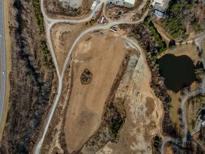 a view of a dry yard with green space