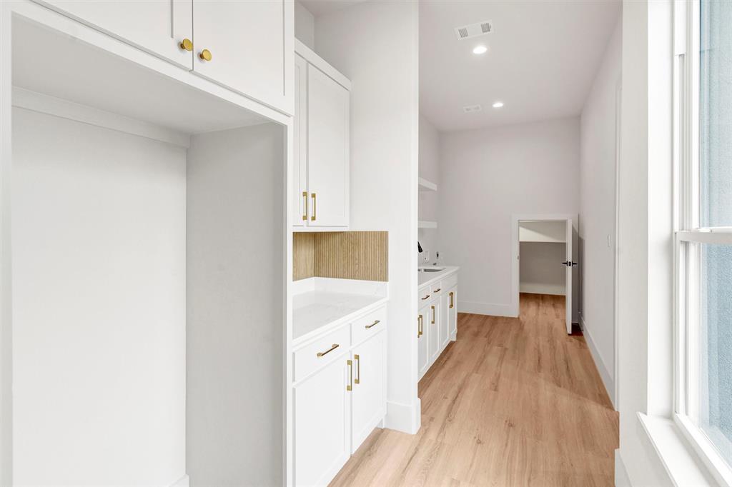 428 Squaw Creek Road Willow Park, TX 76087 - Photo 21 of 34 a view of a hallway with wooden floor and a bathroom