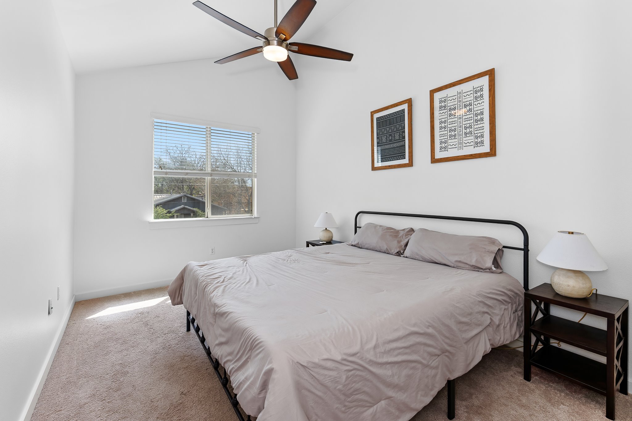 4408 Banister Lane, Unit B Austin, TX 78745 - Photo 28 of 28 a bedroom with a large bed and a chandelier