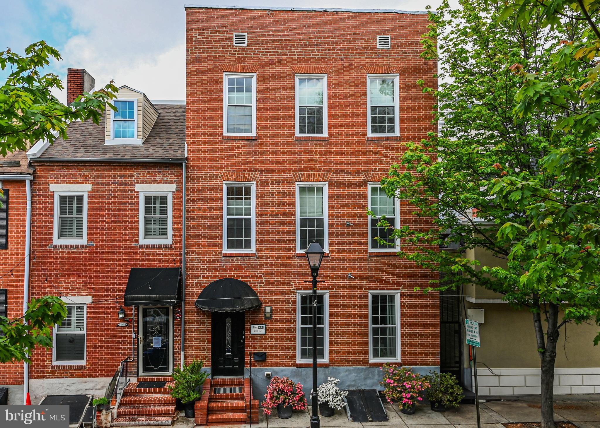 210 South High Street Baltimore, MD 21202 - Photo 1 of 80 front view of a brick house with a large windows and a potted plant