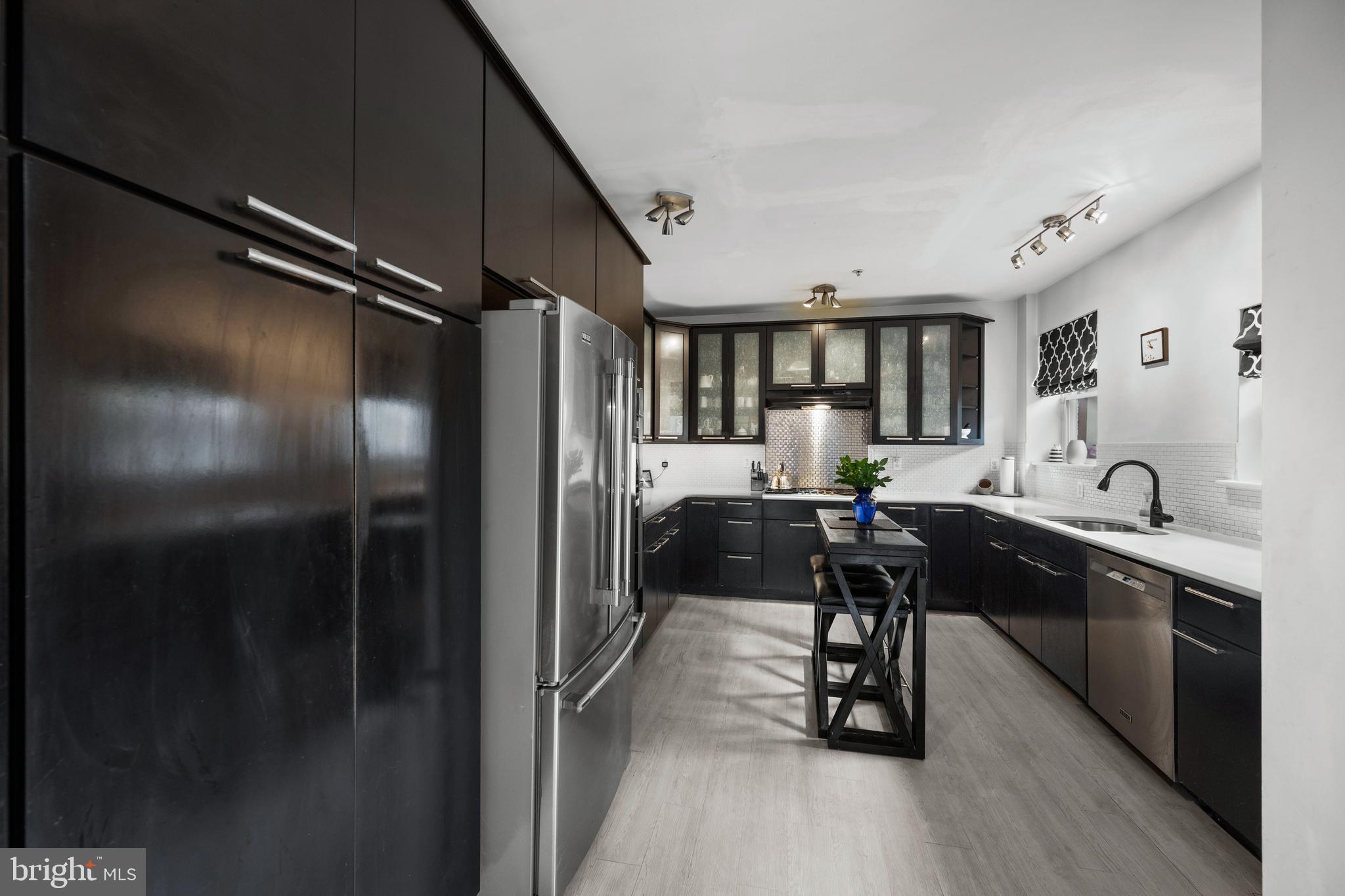 210 South High Street Baltimore, MD 21202 - Photo 14 of 80 a kitchen with counter top space and stainless steel appliances