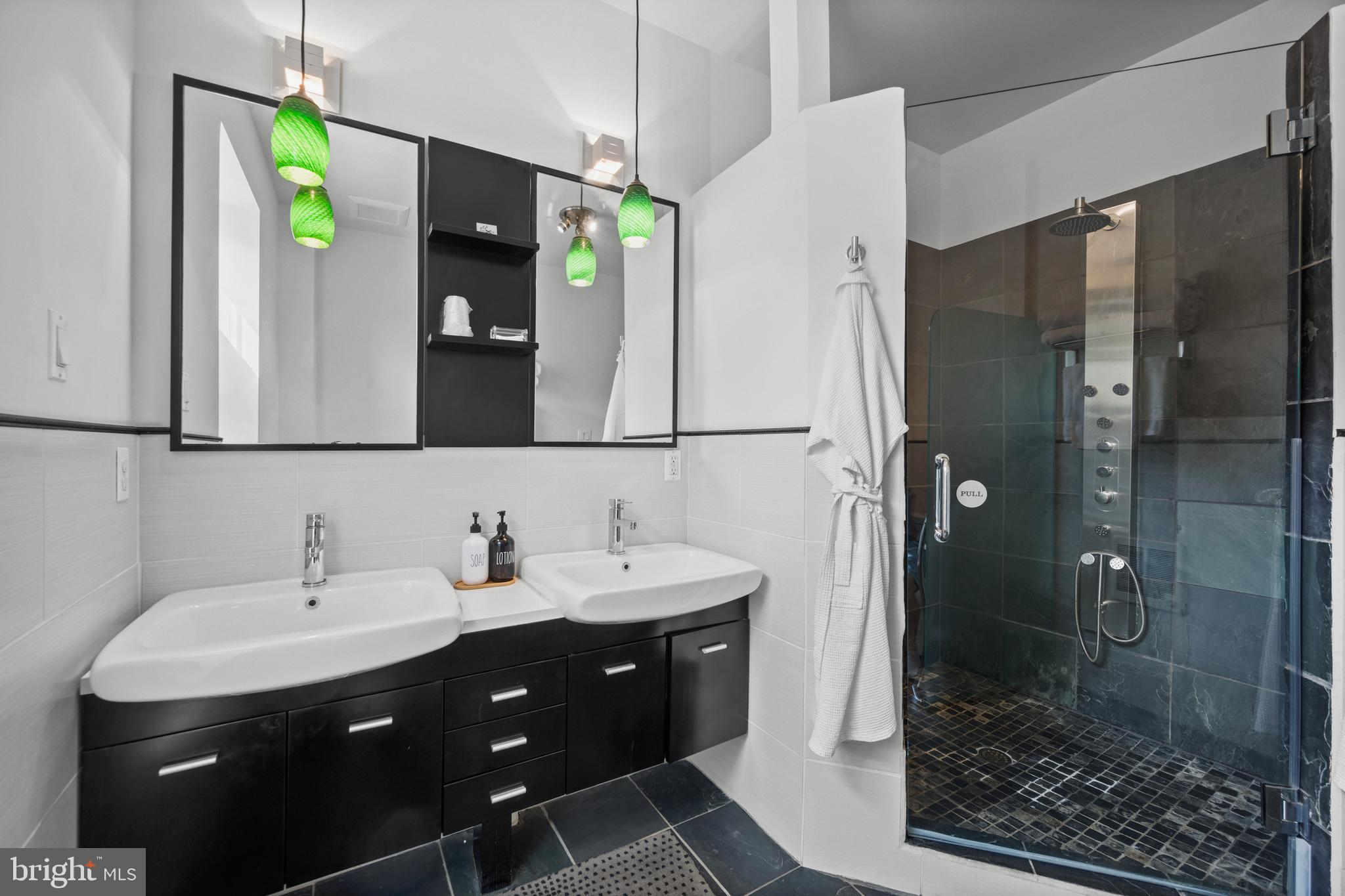 210 South High Street Baltimore, MD 21202 - Photo 25 of 80 a bathroom with a double vanity sink and mirror