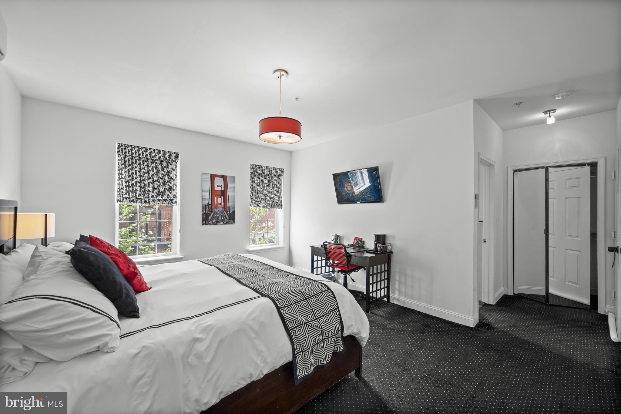 210 South High Street Baltimore, MD 21202 - Photo 34 of 80 a bedroom with a bed and a chandelier