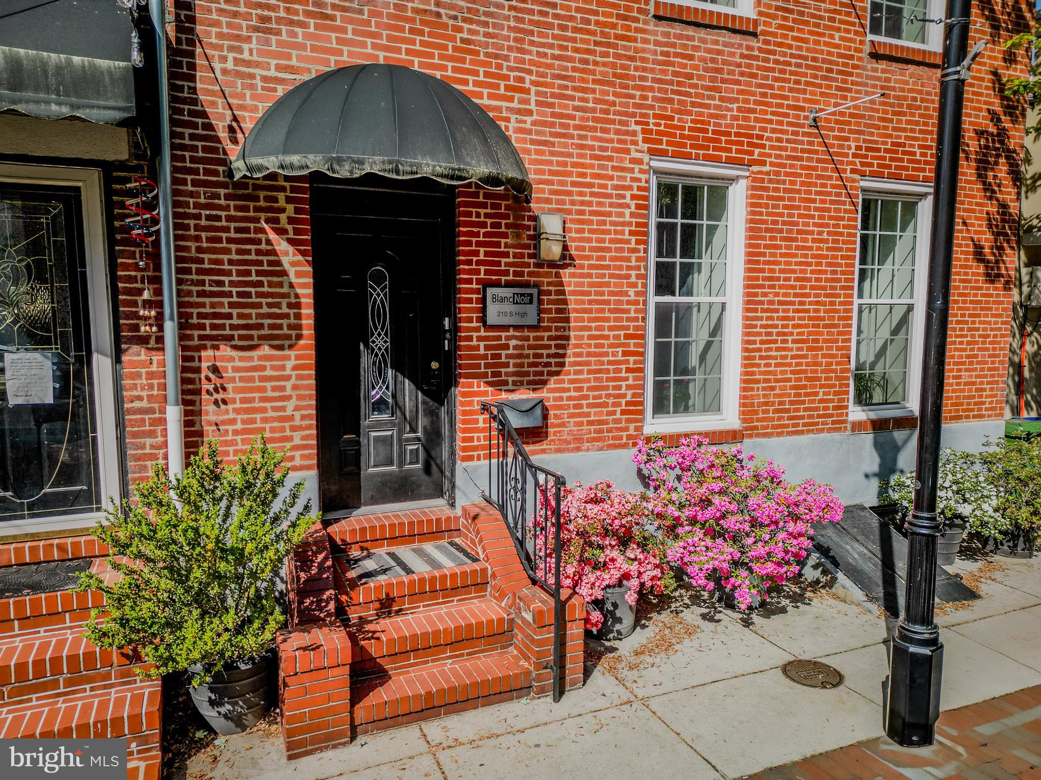 210 South High Street Baltimore, MD 21202 - Photo 4 of 80 a front view of a house with flower plants