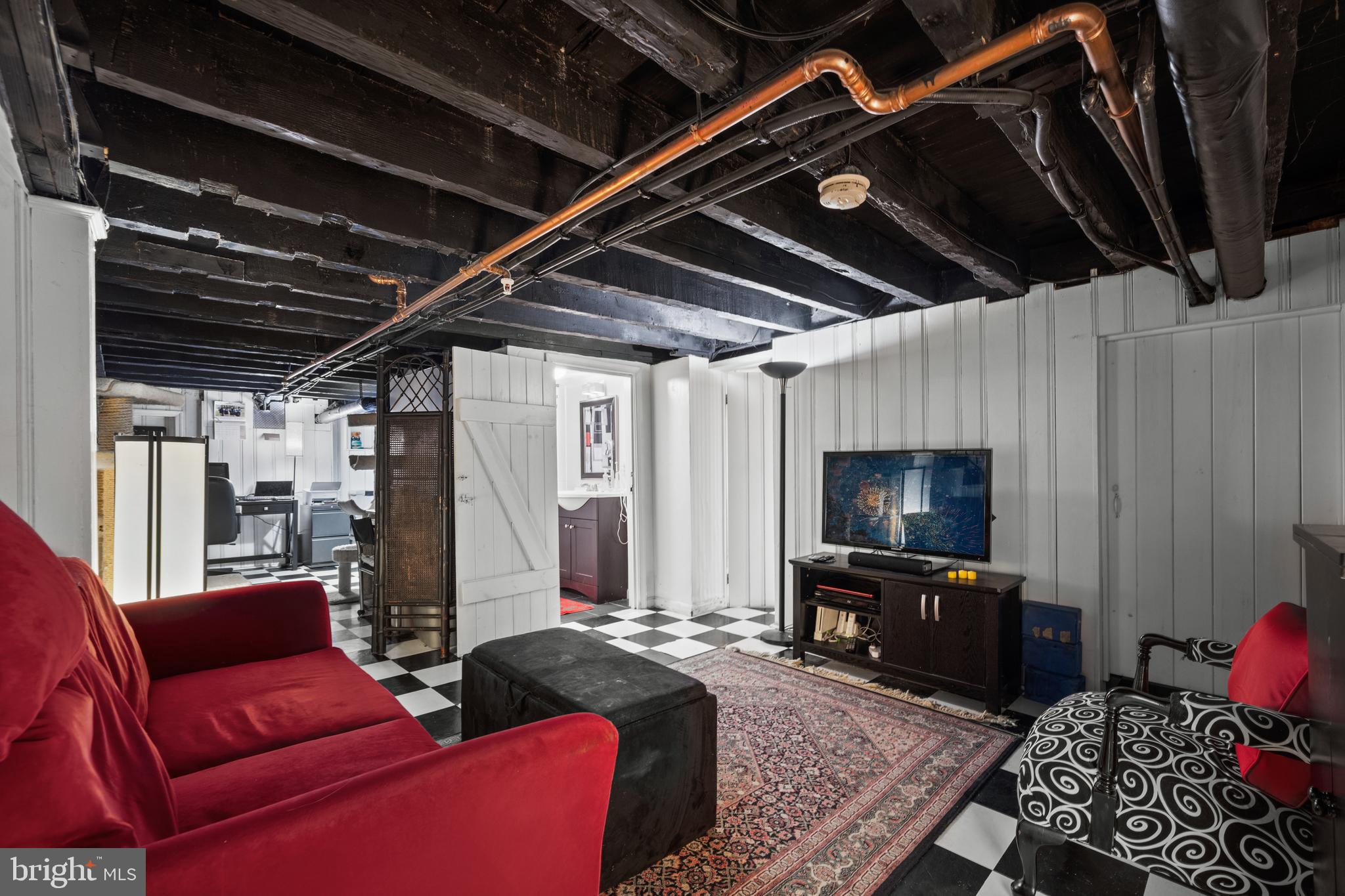 210 South High Street Baltimore, MD 21202 - Photo 41 of 80 a living room with furniture and a flat screen tv