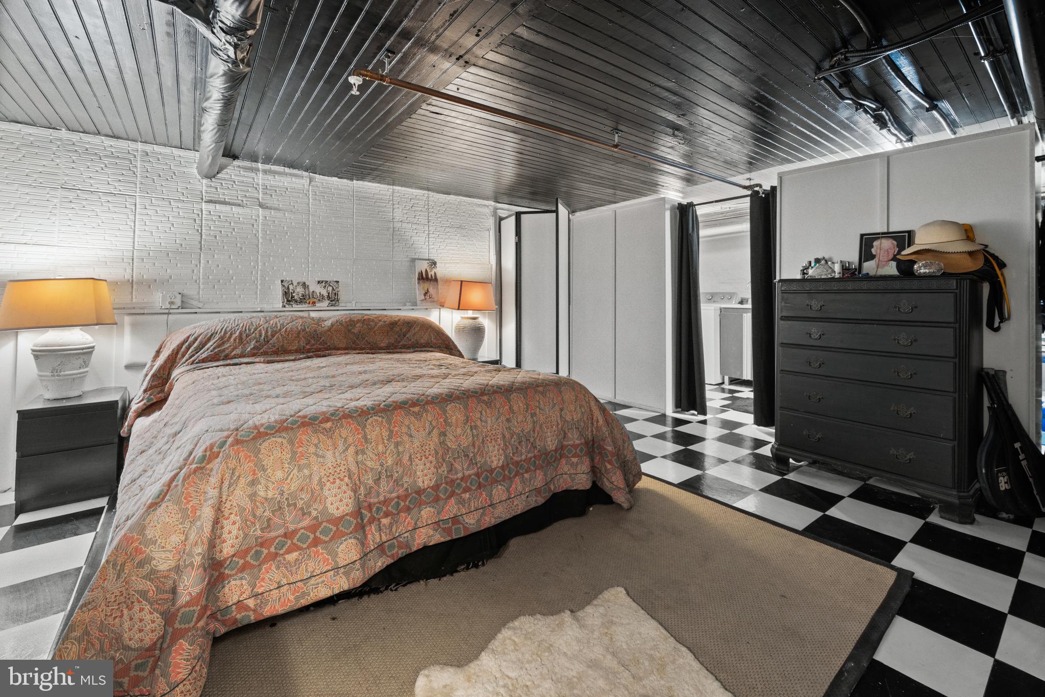 210 South High Street Baltimore, MD 21202 - Photo 46 of 80 a bed sitting in a room next to a window