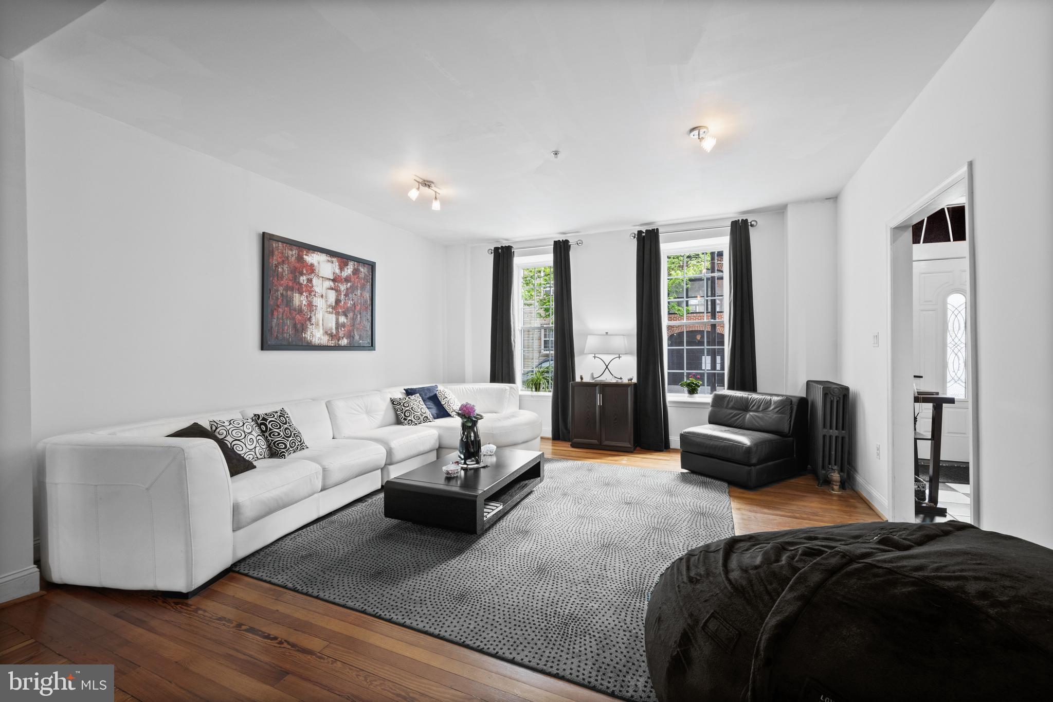 210 South High Street Baltimore, MD 21202 - Photo 7 of 80 a bedroom with a bed couch and a large window