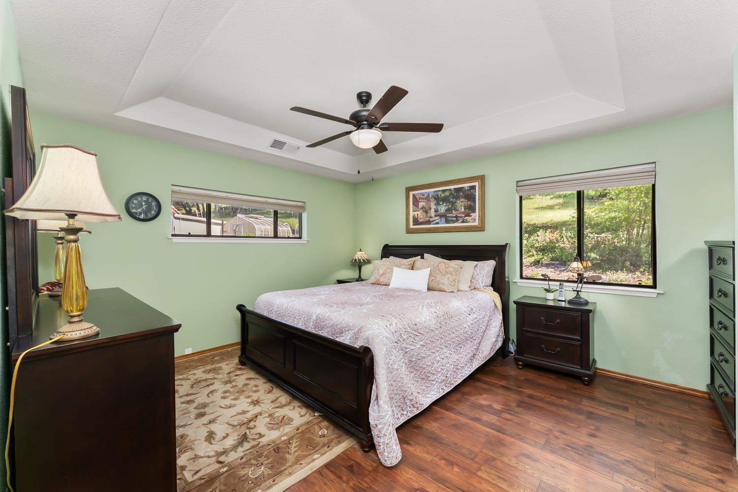 19461 Fiddletown Road Fiddletown, CA 95629 - Photo 18 of 62 a bedroom with a bed and a chandelier