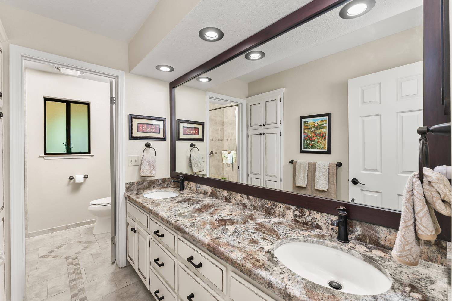 19461 Fiddletown Road Fiddletown, CA 95629 - Photo 25 of 62 a bathroom with a granite countertop double vanity sink and a mirror