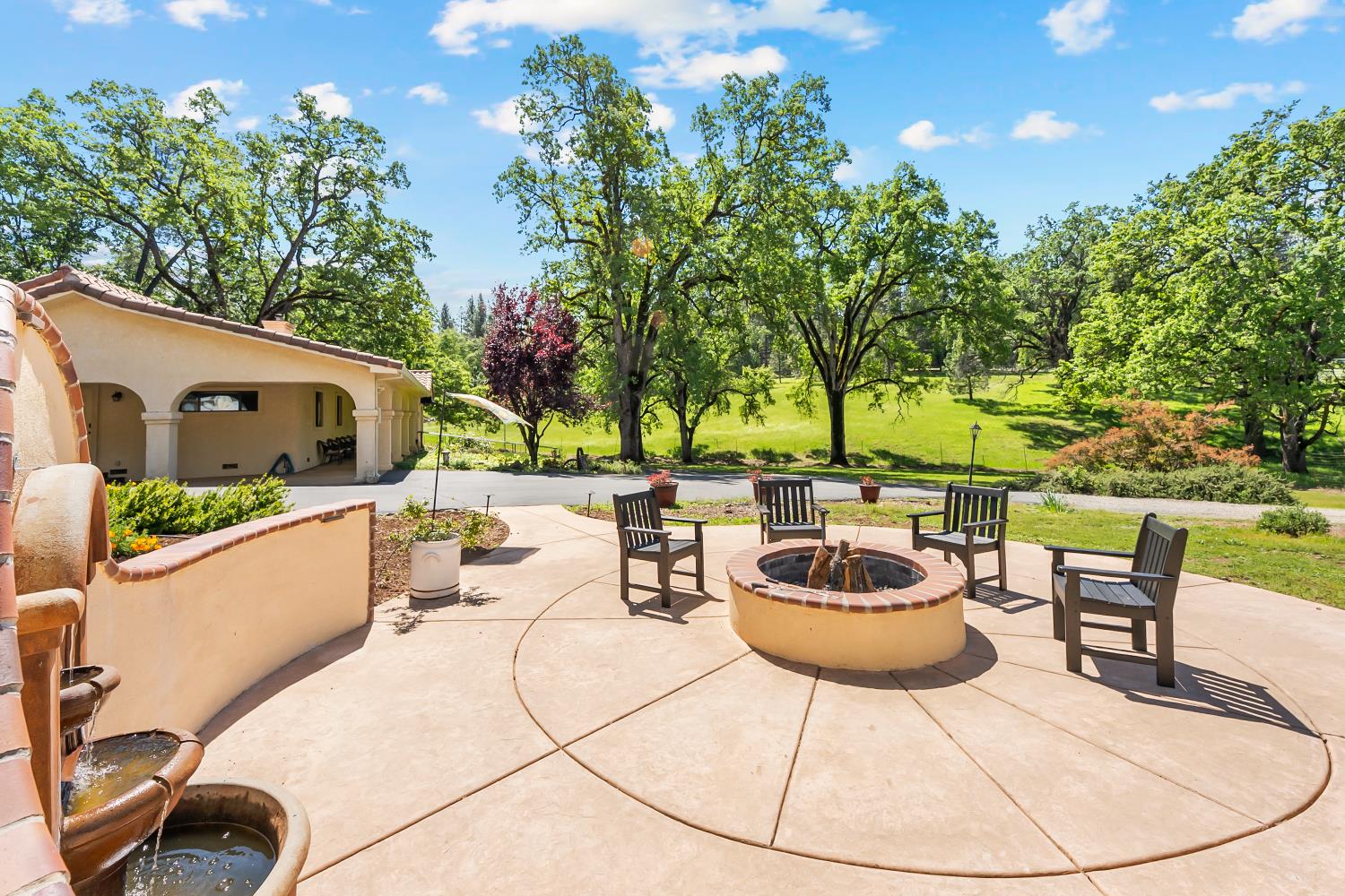 19461 Fiddletown Road Fiddletown, CA 95629 - Photo 36 of 62 a view of a patio with table and chairs potted plants and a palm tree