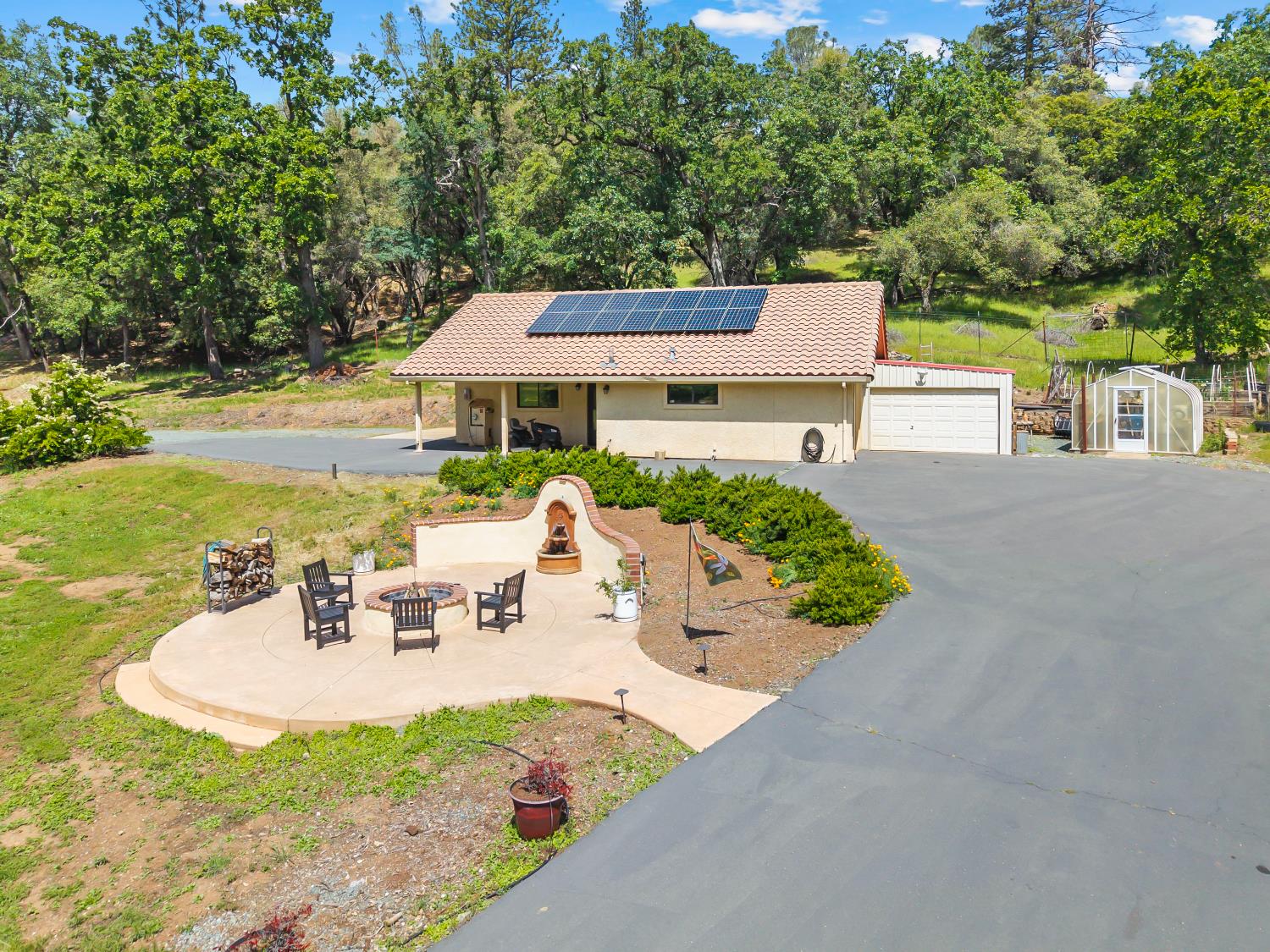 19461 Fiddletown Road Fiddletown, CA 95629 - Photo 55 of 62 a view of a patio with couches table and chairs and potted plants with large tree