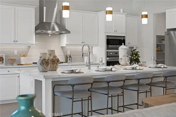 a kitchen with a sink and a stove with white countertops