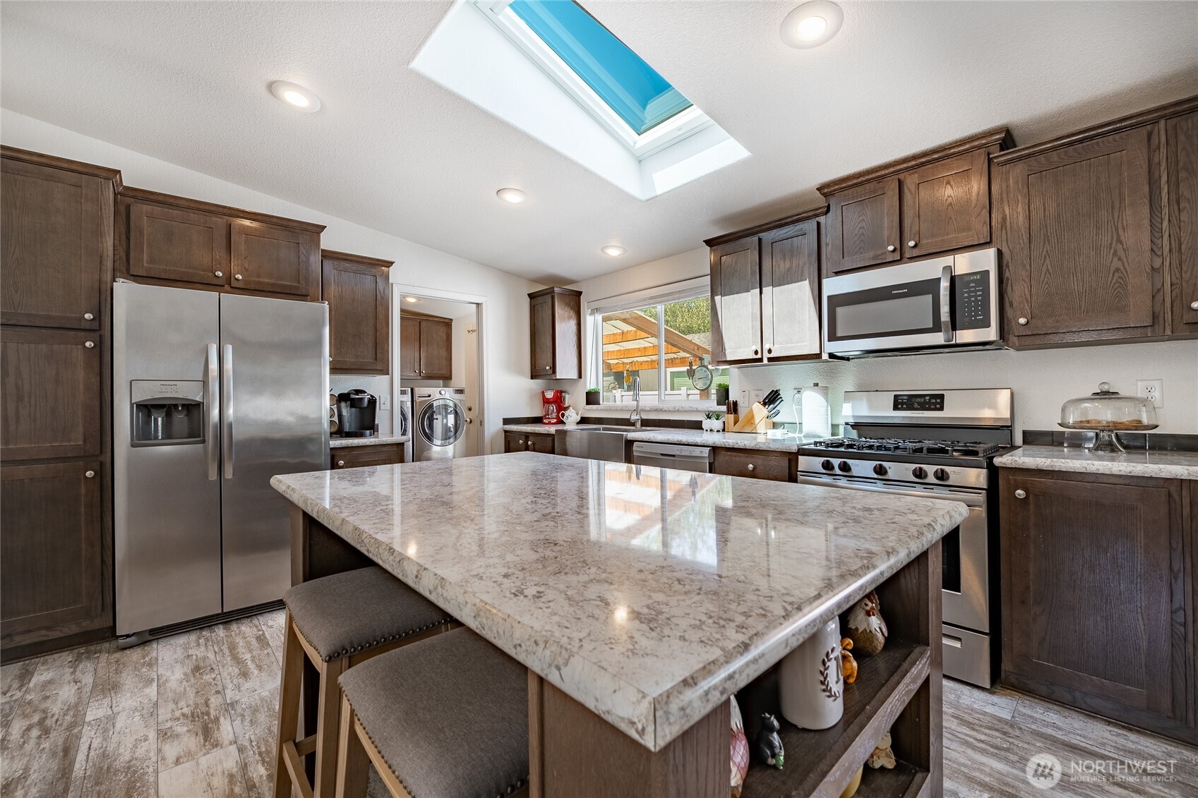 6350 Portal Way, Unit 83 Ferndale, WA 98248 - Photo 11 of 40 a kitchen with stainless steel appliances granite countertop a sink a stove and a refrigerator