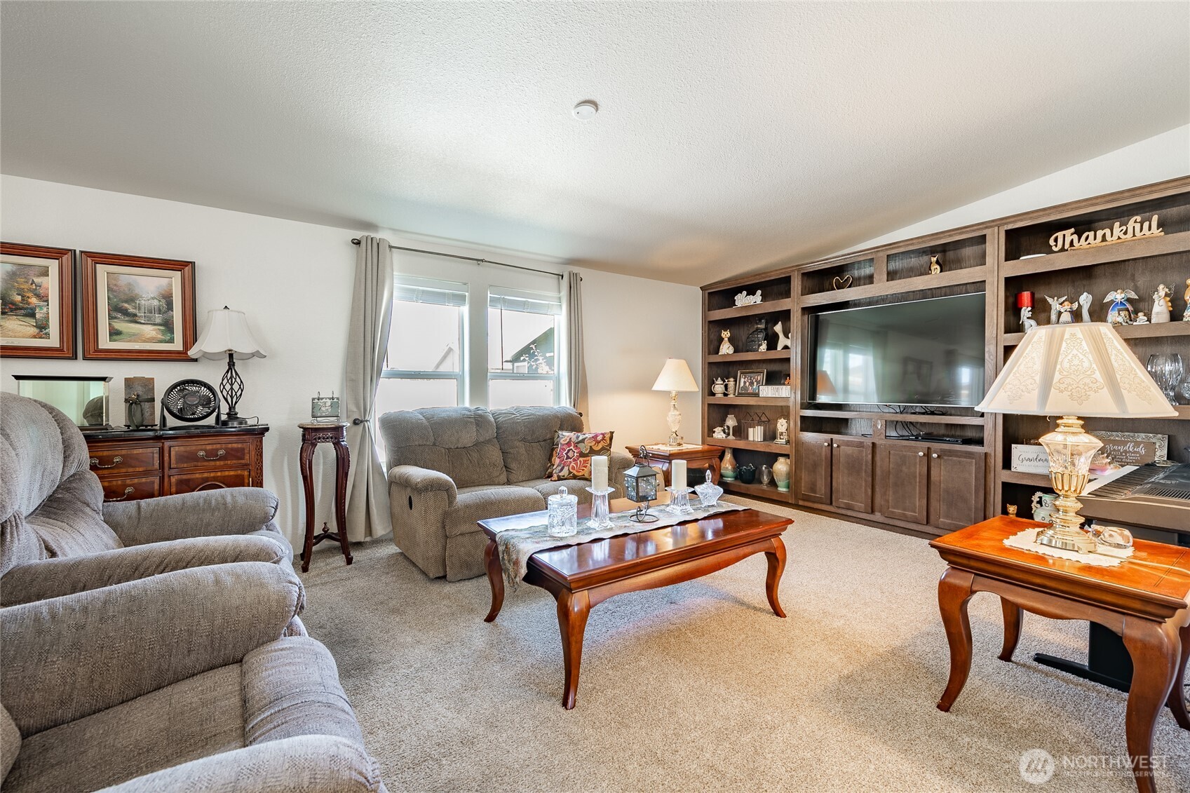 6350 Portal Way, Unit 83 Ferndale, WA 98248 - Photo 18 of 40 a living room with furniture a flat screen tv and a window