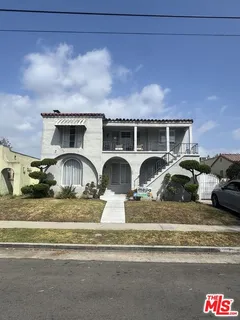 a couple of cars parked in front of a house