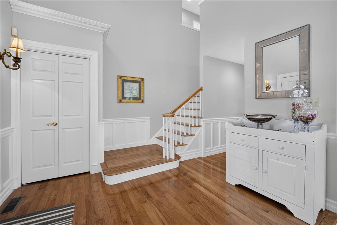 6467 Abbey Road Wind Gap, PA 18091 - Photo 6 of 46 A graceful foyer with gleaming wood floors and a charming staircase sets an inviting tone.