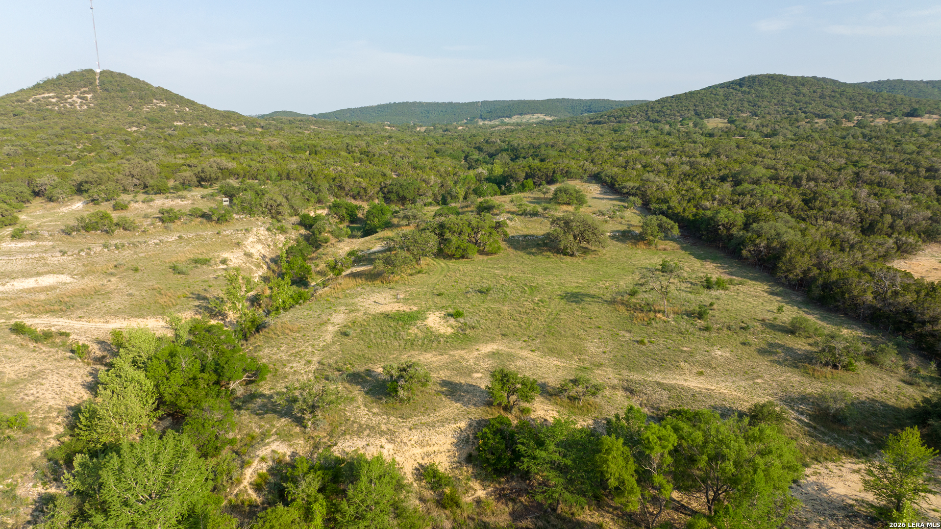 2991 Fm 470 Bandera, TX 78003 - Photo 29 of 46 a view of a lush green hillside and houses