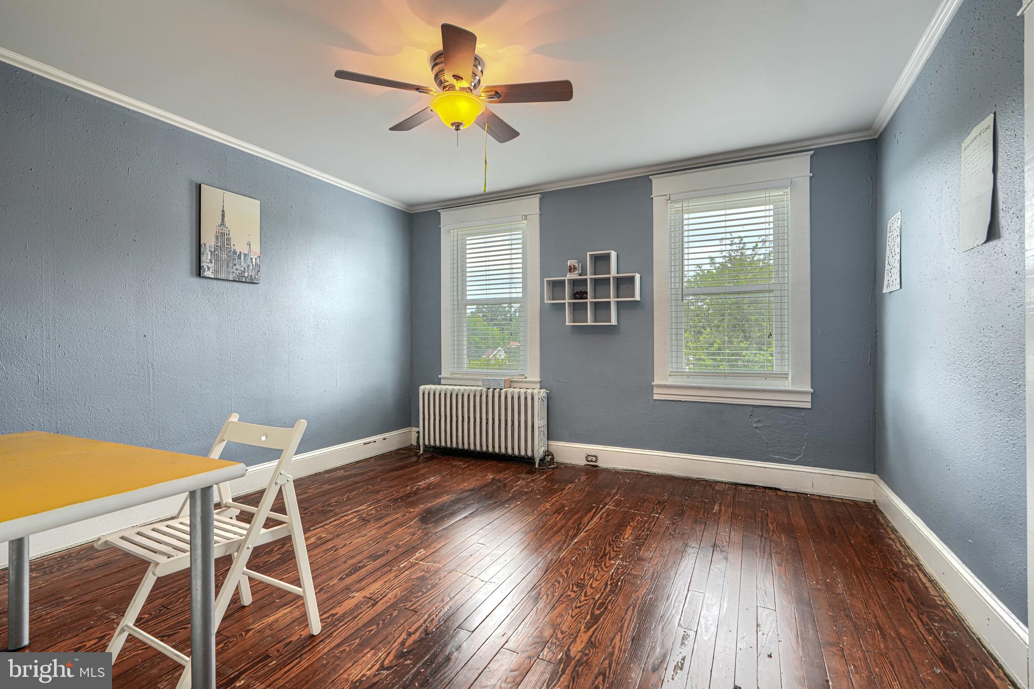 2705 Latona Road Baltimore, MD 21214 - Photo 31 of 53 a view of an empty room with a window and wooden floor
