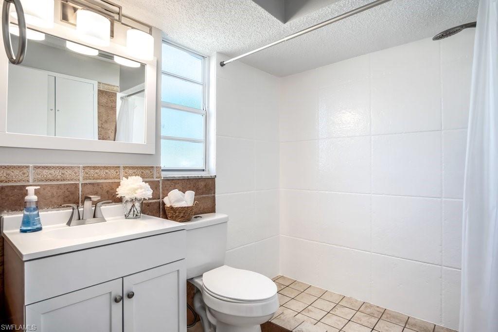 1207 Hernando Street Naples, FL 34103 - Photo 20 of 37 a bathroom with a sink a toilet and shower