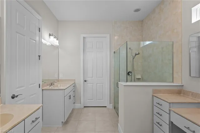 a bathroom with a sink a toilet a shower and a mirror