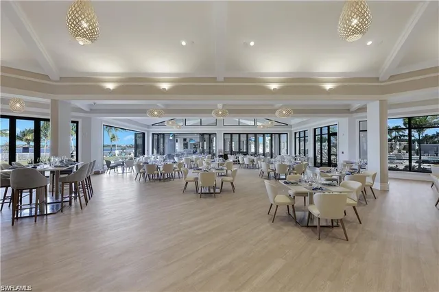 a kitchen with stainless steel appliances kitchen island granite countertop a dining table chairs and granite counter tops