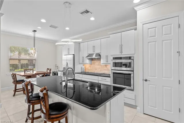 a kitchen with a stove a sink and a refrigerator