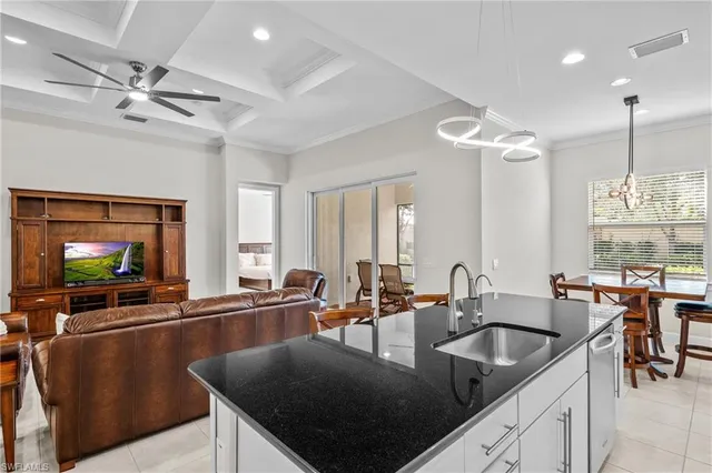 a kitchen with a table chairs sink and cabinets