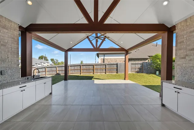 a large white kitchen with a large window