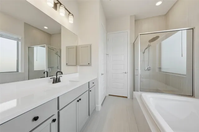 a bathroom with a double vanity sink mirror double and shower